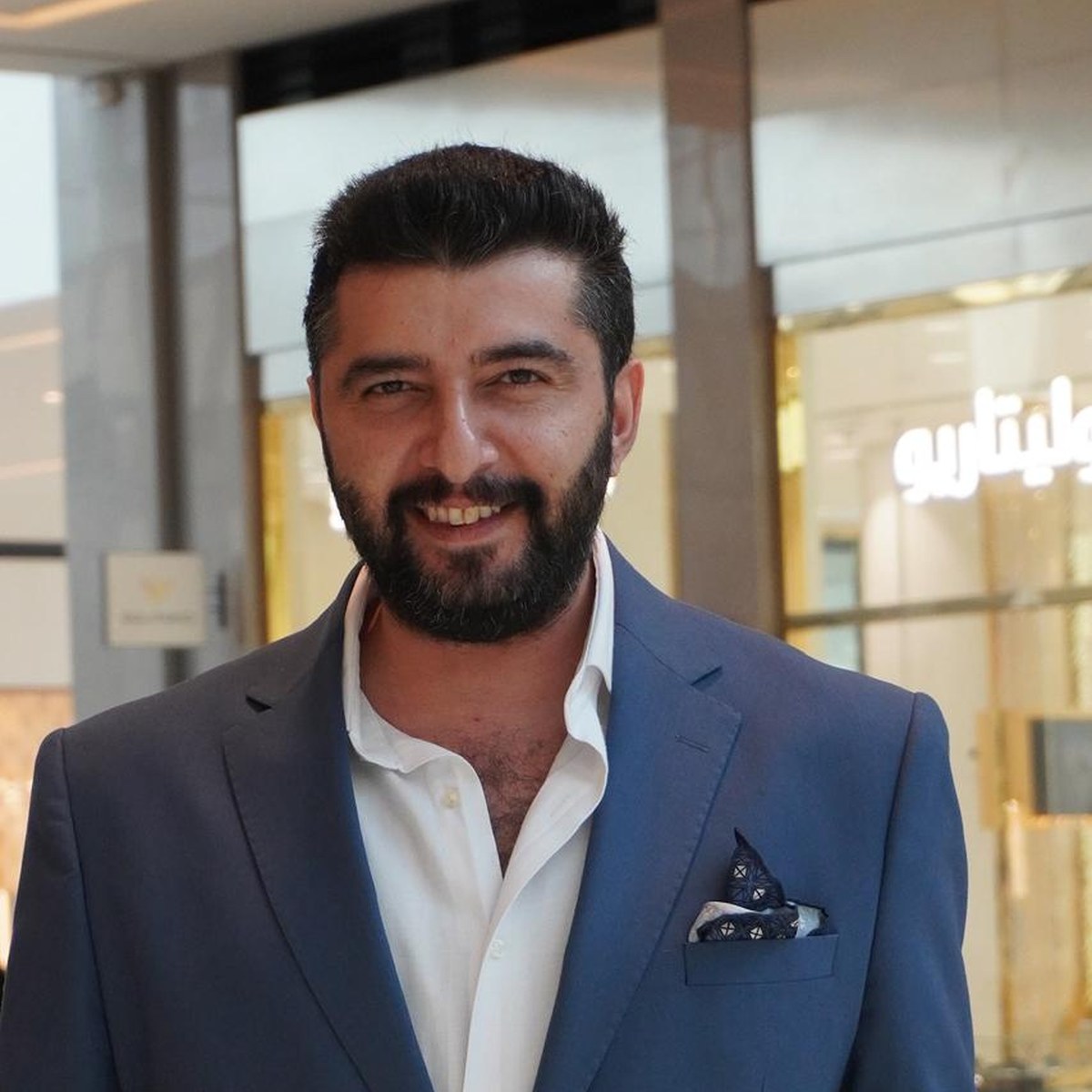 Portrait of Burak Sarıkaya in a suit